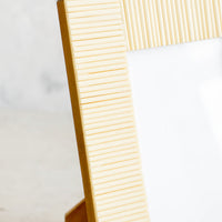 2: Picture frame made from cream colored bone with ribbed texture