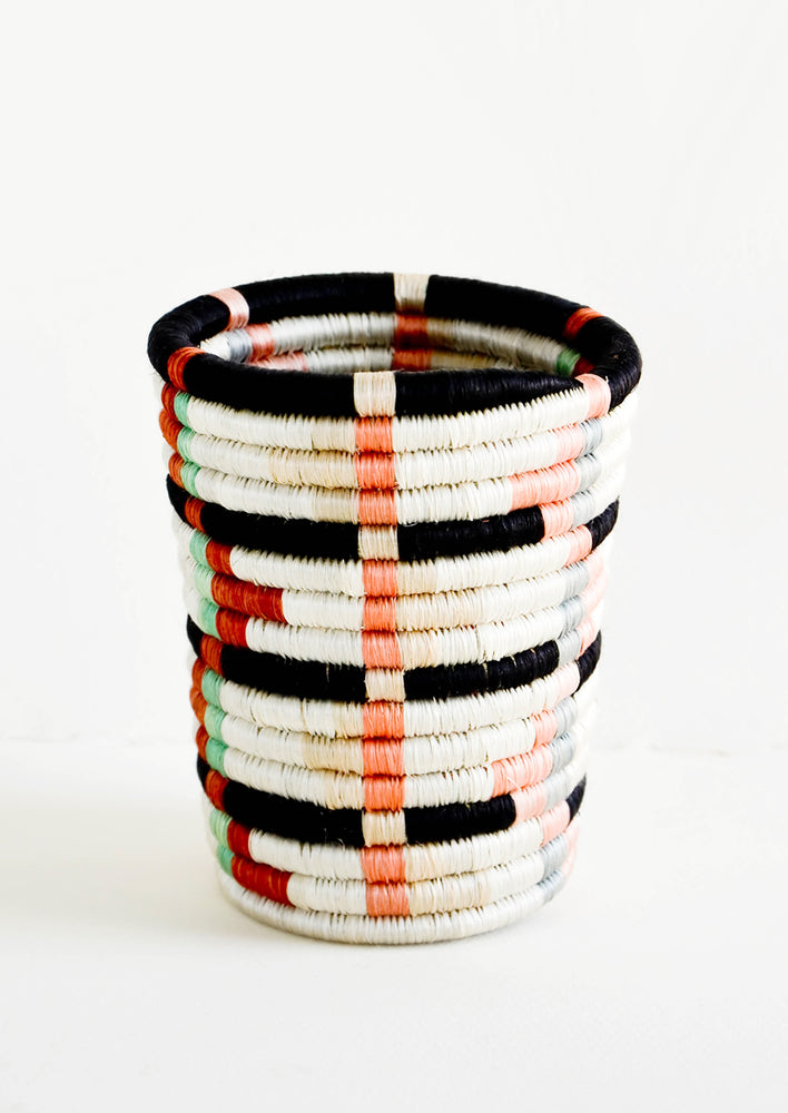 Pencil cup shaped baskets woven from multicolor sweetgrass. Mix of pastel colors in a geometric pattern.
