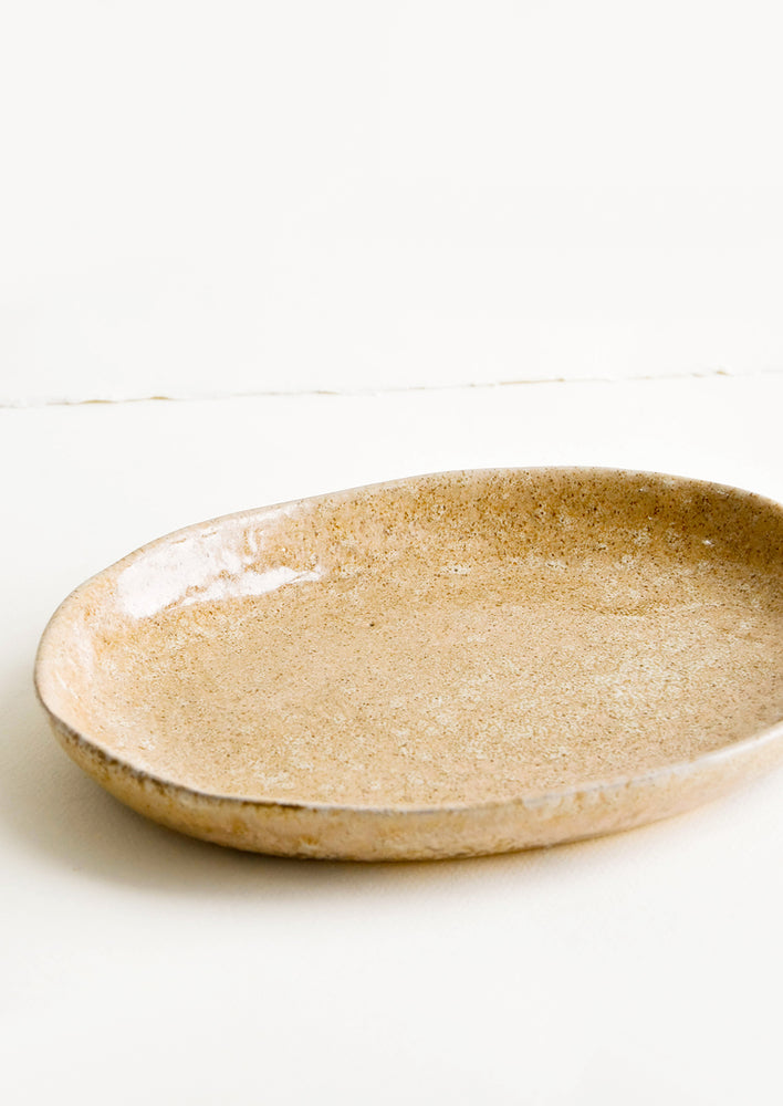 Oval shaped ceramic platter in reactive brown-peach glaze