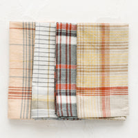 2: A set of four napkins in plaid pattern and assorted colors.
