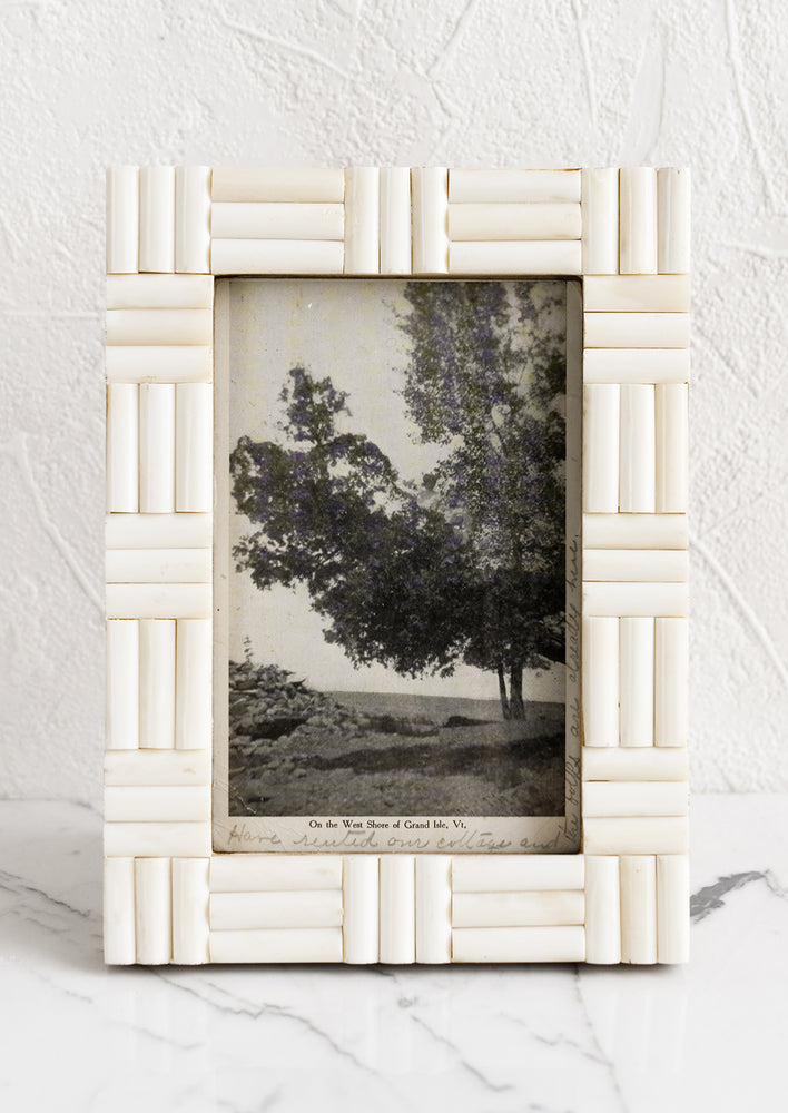 1: An ivory picture frame with alternating direction inlay.