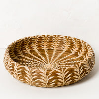 1: A shallow, round basket with lighter woven pattern throughout.