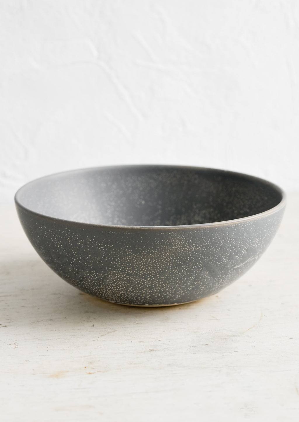 1: A dark grey ceramic bowl with light tan speckles.