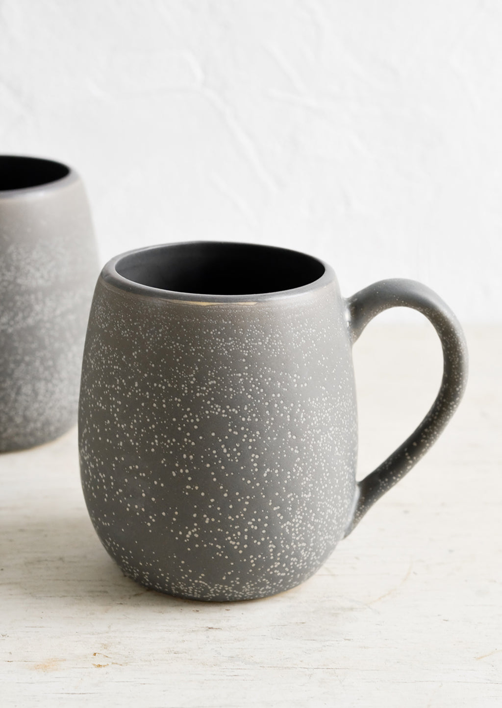2: A large ceramic mug in dark grey with light speckles.