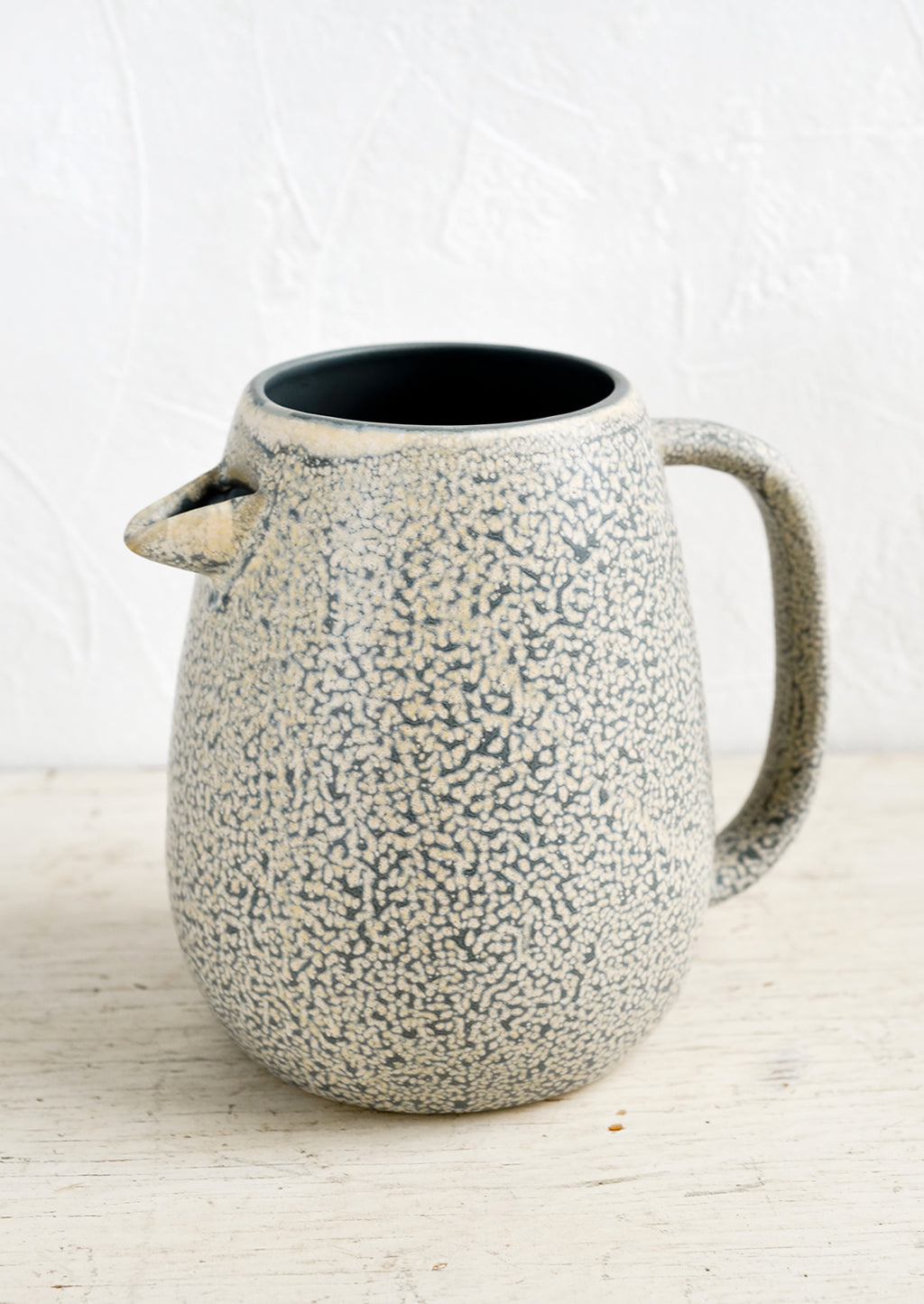 1: A ceramic pitcher with built-in spout in speckled grey and natural glaze.