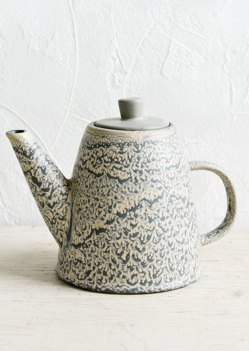 1: A ceramic lidded teapot in grey and natural speckled glaze.
