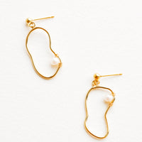 1: Dangling earrings featuring asymmetric round gold charm made from a slim gold hoop, with one pearl attached with wrapped wire.