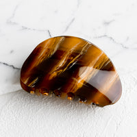 Caramel: An asymmetric hair claw in marbled caramel.