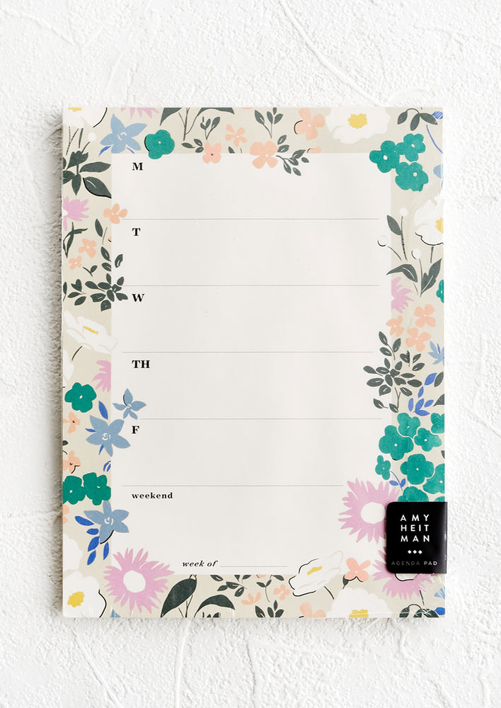 A weekly agenda notepad with floral border.