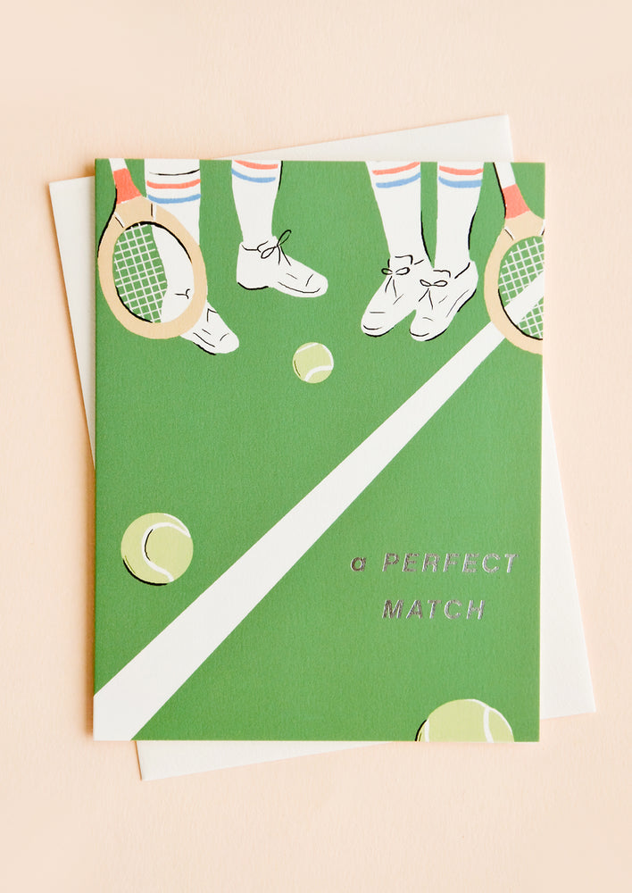 1: Greeting card with tennis court vignette, silver text at corner reads "A perfect match"