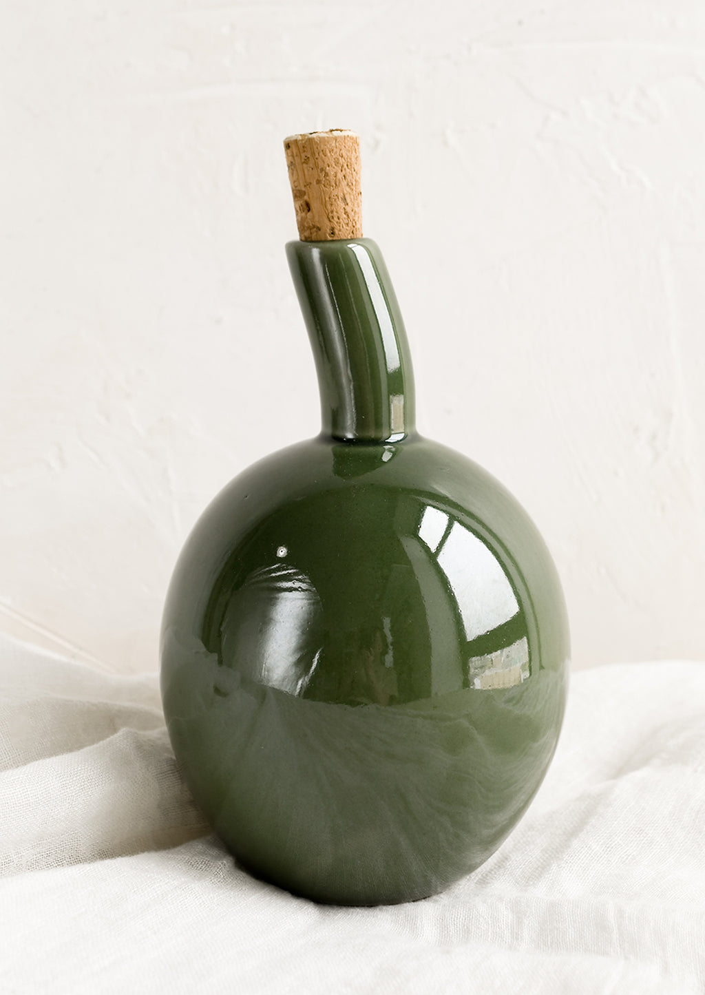 Olive Gloss: A glossy green ceramic cruet bottle with asymmetrical, bulbous silhouette.