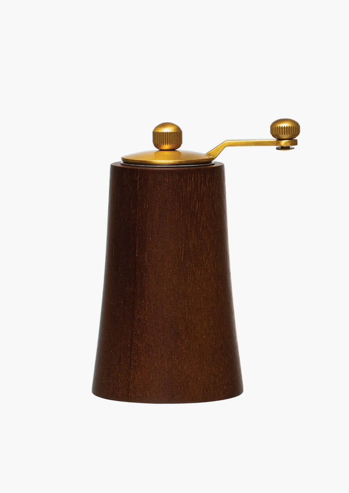 A wood and brass grinder in dark wood.
