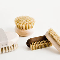 1: Four oval wooden brushes with natural bristles. 
