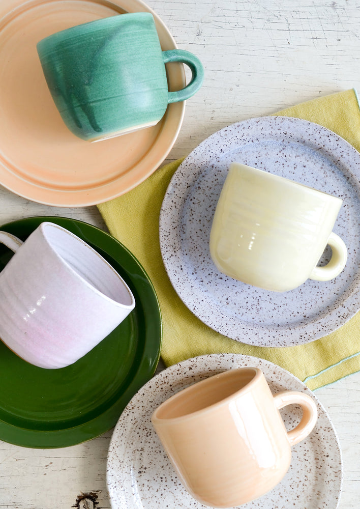 A mix of hand glazed plates and mugs.