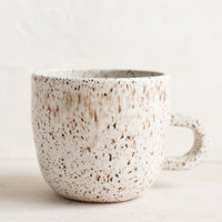 Sparrow Speckle (Satin): A short ceramic coffee mug in matte natural glaze with brown speckles.