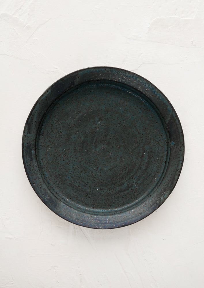Adriatic (Matte): A ceramic side plate in matte deep blue speckle glaze.