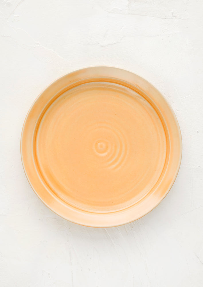 Nectar (Satin): A ceramic side plate in glossy peach glaze.