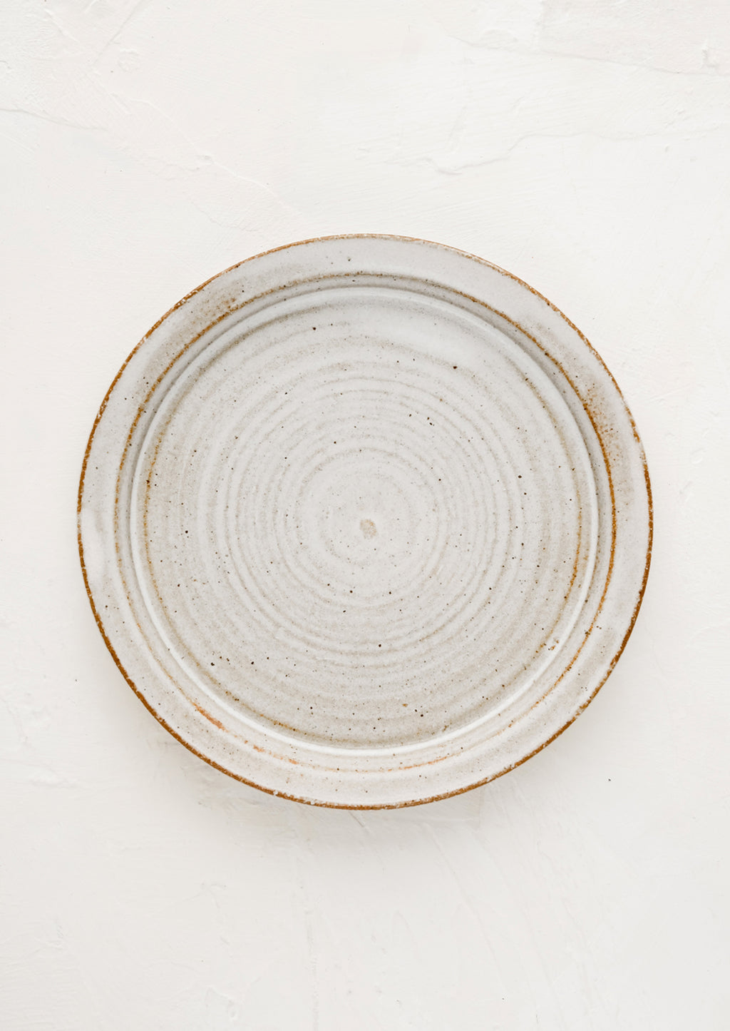 Natural Rustic (Glossy): A ceramic side plate in natural rustic glaze.
