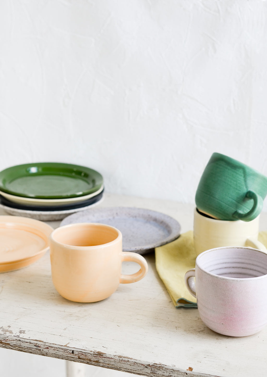 10: A mix of hand glazed plates and mugs.