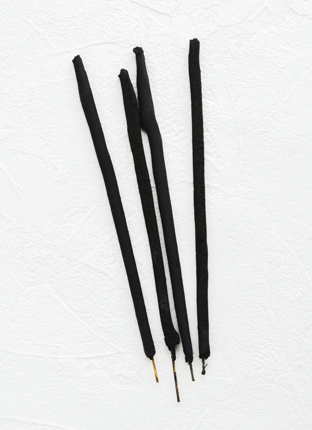 2: Black sticks of incense.