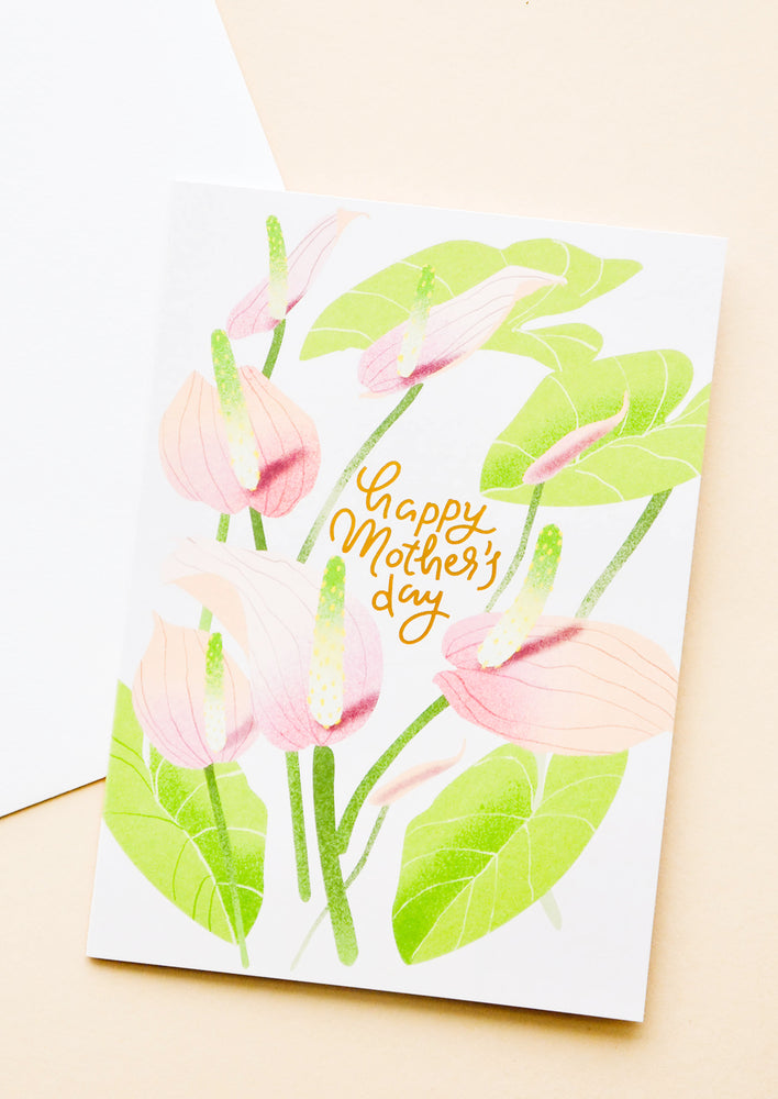 1: Greeting card with painted anthurium stems and "happy mothers day" written in gold. Shown with white envelope.
