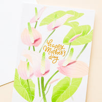 1: Greeting card with painted anthurium stems and "happy mothers day" written in gold. Shown with white envelope.