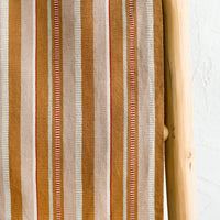 3: A close up of striped cotton fabric.