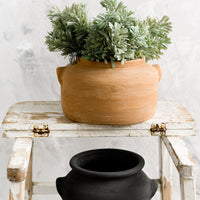 3: Weathered clay pots on a step stool.