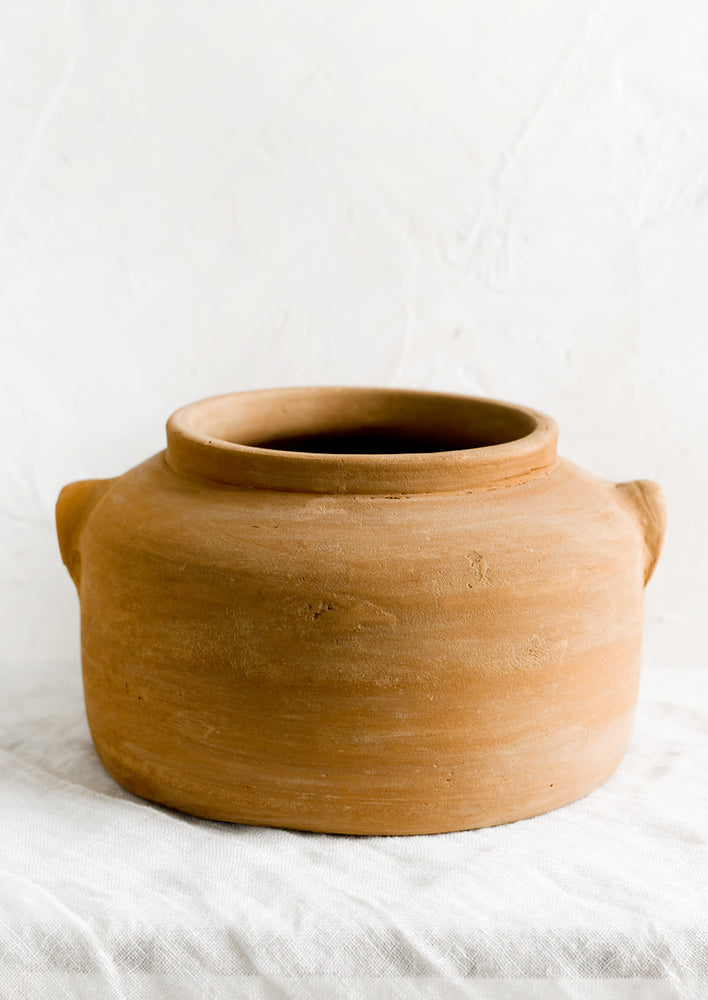 A low and wide terracotta planter.