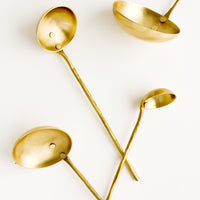 1: A set of four ladles in incremental sizes from extra small to large, crafted in solid brass with skinny handles