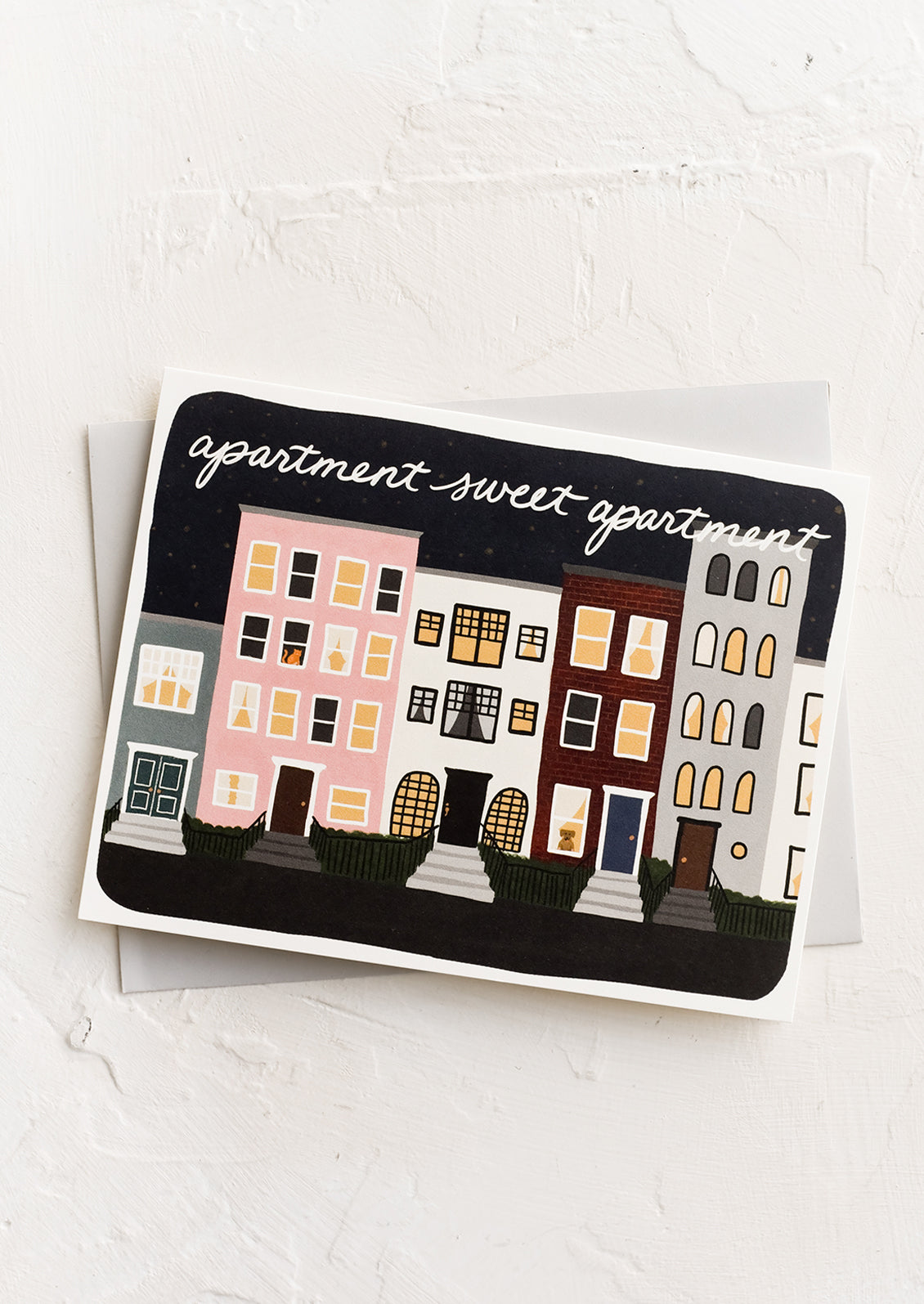 A greeting card with illustration of row houses.