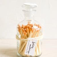 Tangelo: Safety matches with orange tips in a vintage-style glass apothecary jar with white wax seal on lid.