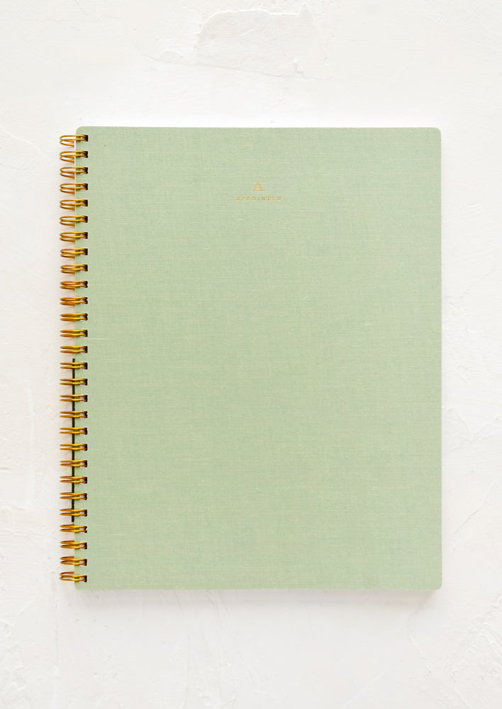 A spiral bound notebook in green.