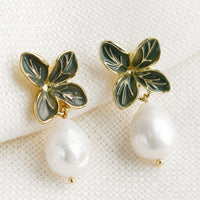 Four Leaf: A pair of earrings with four leaf enamel post and pearl.