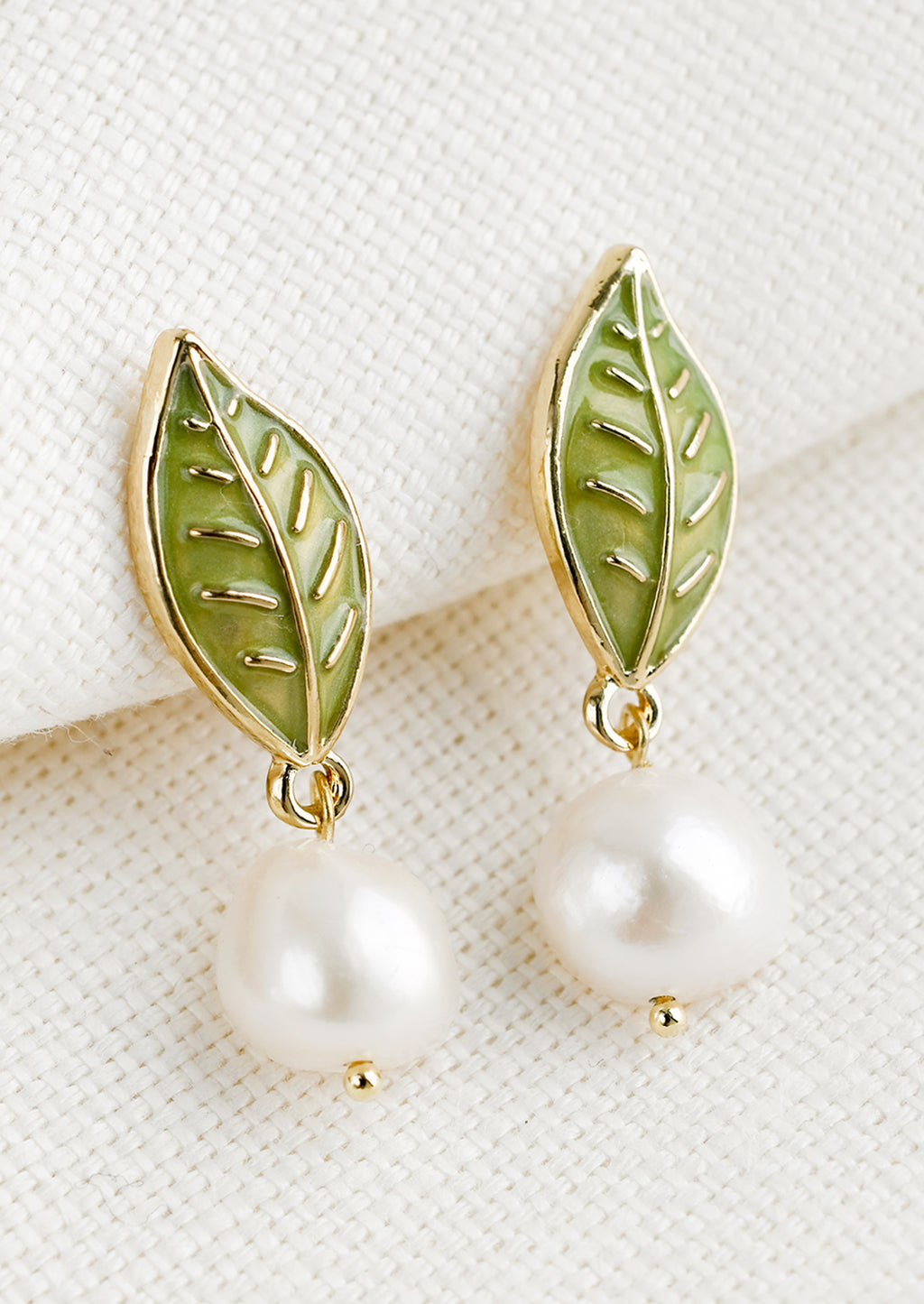 Single Leaf: A pair of earrings with leaf enamel post and pearl.