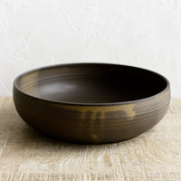 Matte Earth: A ceramic serving bowl in matte brown.