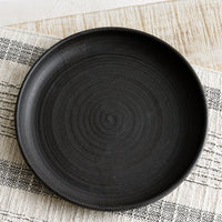 Meteor Black: A shallow serving plate in matte black.