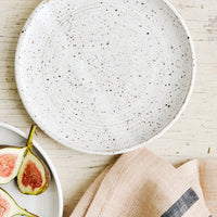 Speckled White / Dessert Plate: A ceramic side plate in matte white with dark speckles.
