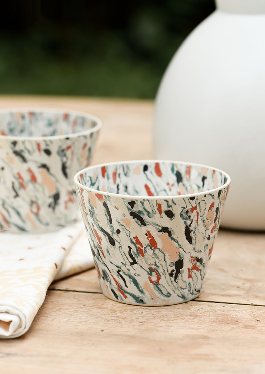 2: Marbleized porcelain cups on a table.