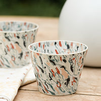 2: Marbleized porcelain cups on a table.