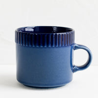 Cobalt: A ceramic mug in cobalt blue with ribbed tonal border along rim.