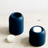 1: Ceramic tealight holders in jewel-tone blue, shown on table with tealights
