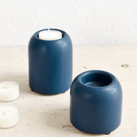 2: Ceramic tealight holders in jewel-tone blue, shown on table with tealights
