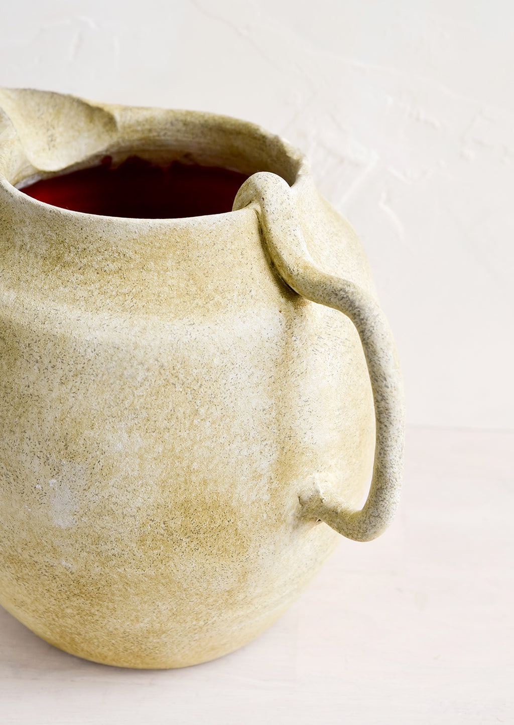 3: Curved handle on a ceramic pitcher.