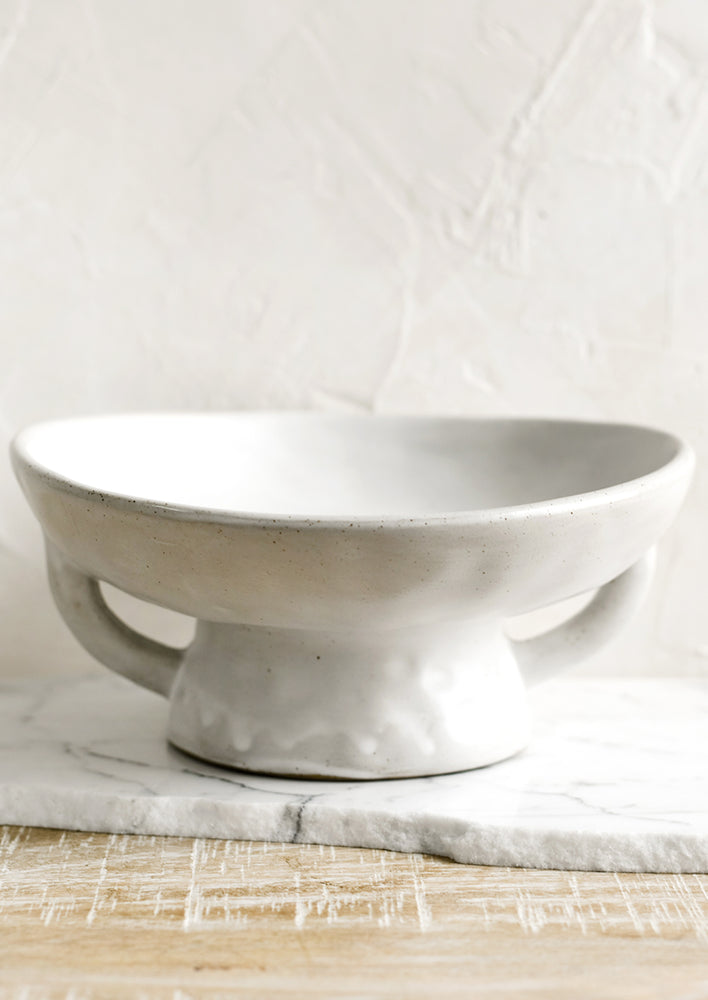A white footed ceramic bowl.