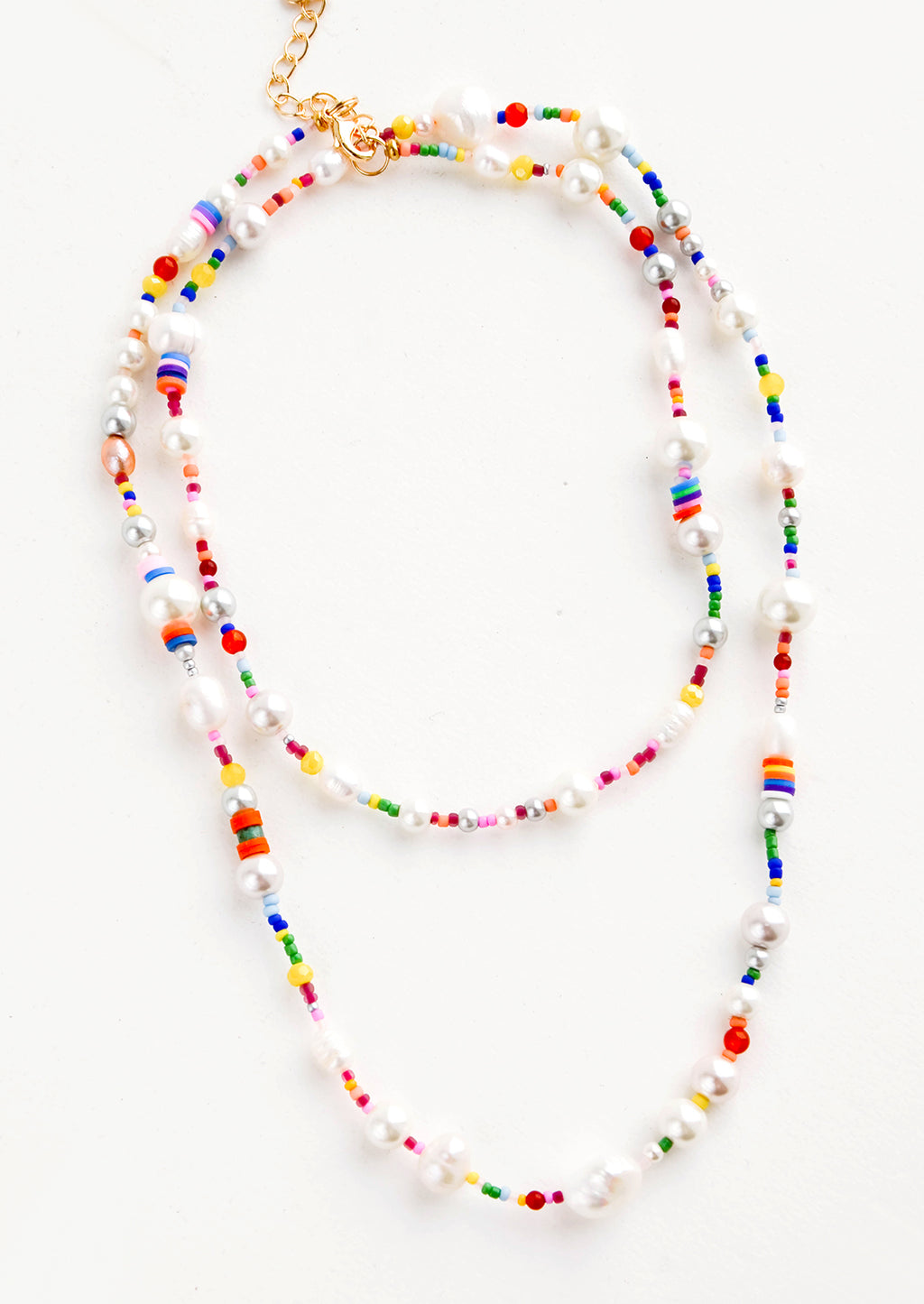 1: Long, layered beaded necklace in a mix of round pearl beads and rainbow colored beads