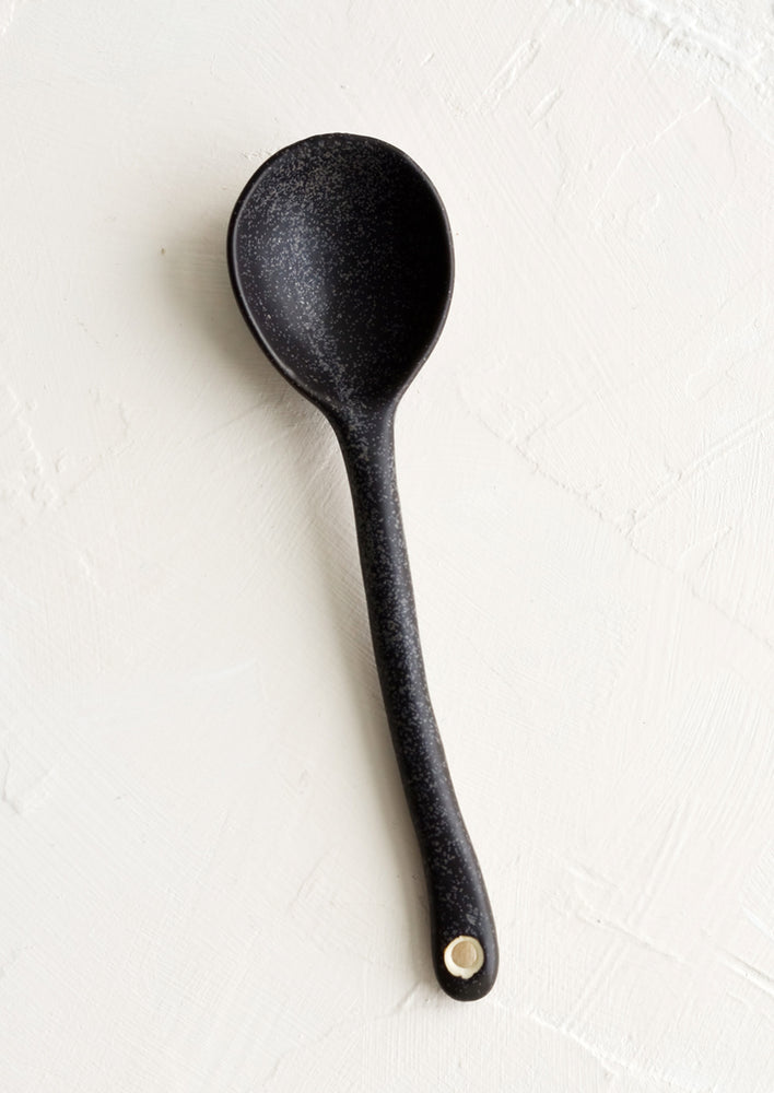 Dark: A ceramic spoon in speckled black.