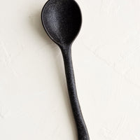 Dark: A ceramic spoon in speckled black.
