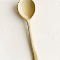 Light: A ceramic spoon in natural tan.
