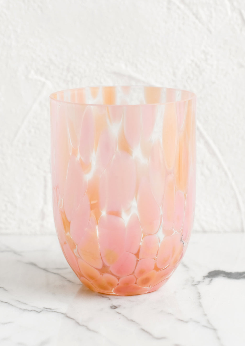 Peach / Maxi: A handmade speckled glass juice cup with peach and pink spots.